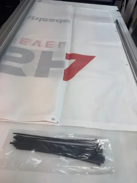 Custom printed banner with metal grommets and a pack of cable ties for hanging.