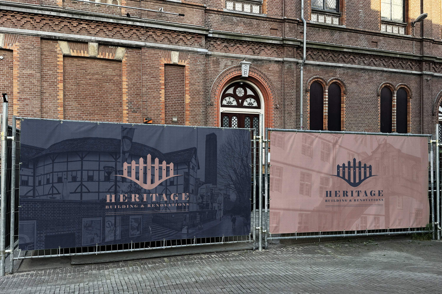 Custom printed Heras fence covers with Heritage Building & Renovations logo outside a brick building