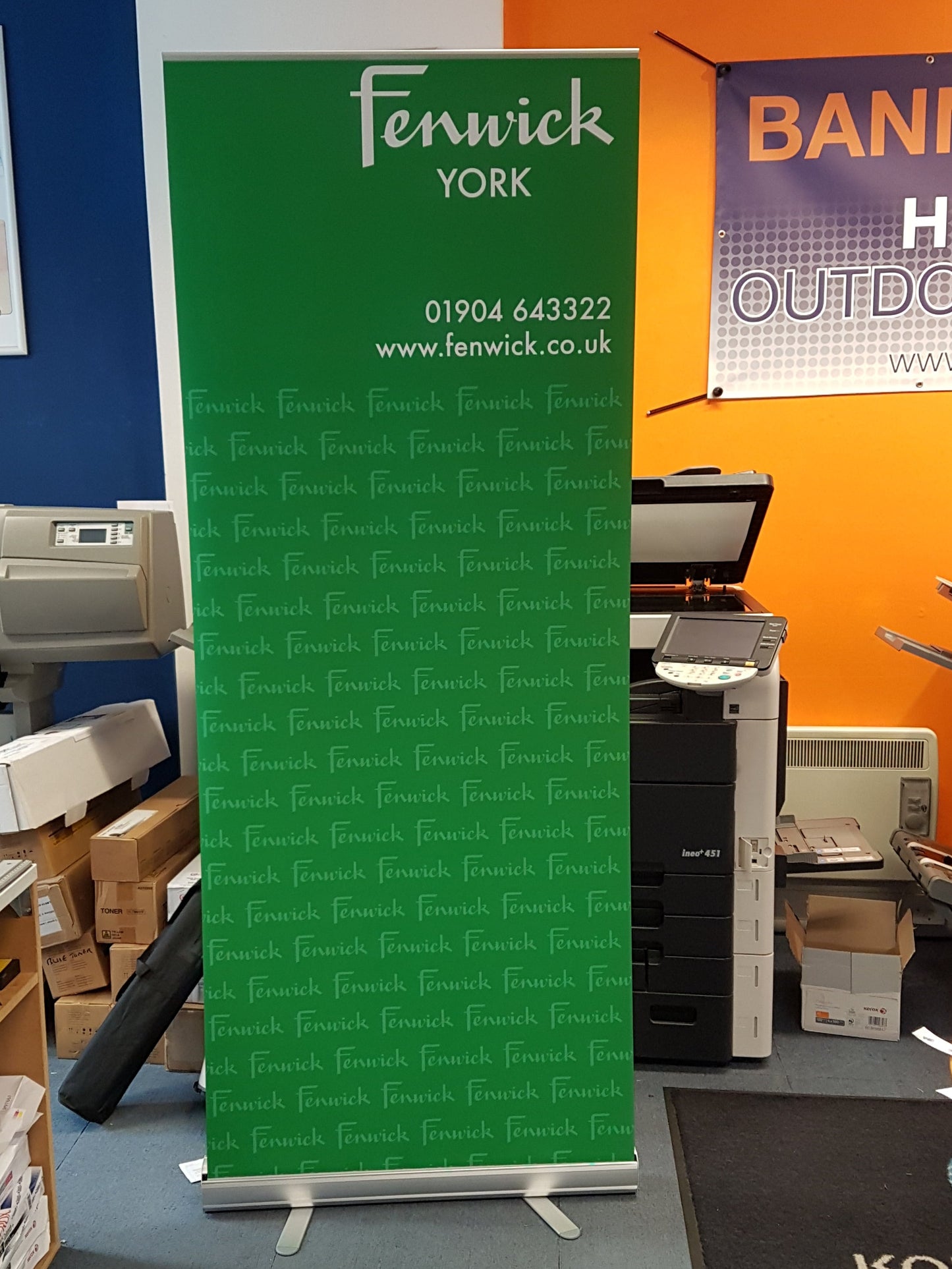 Green banner with 'Fenwick York' branding in a printing or office setting.